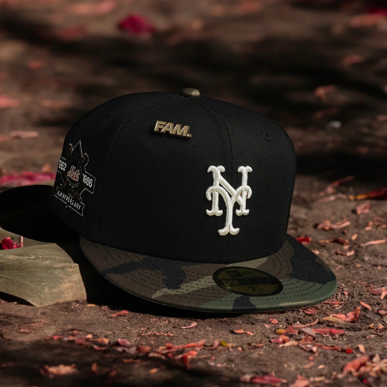 Black and camouflage baseball cap with logo on a textured surface