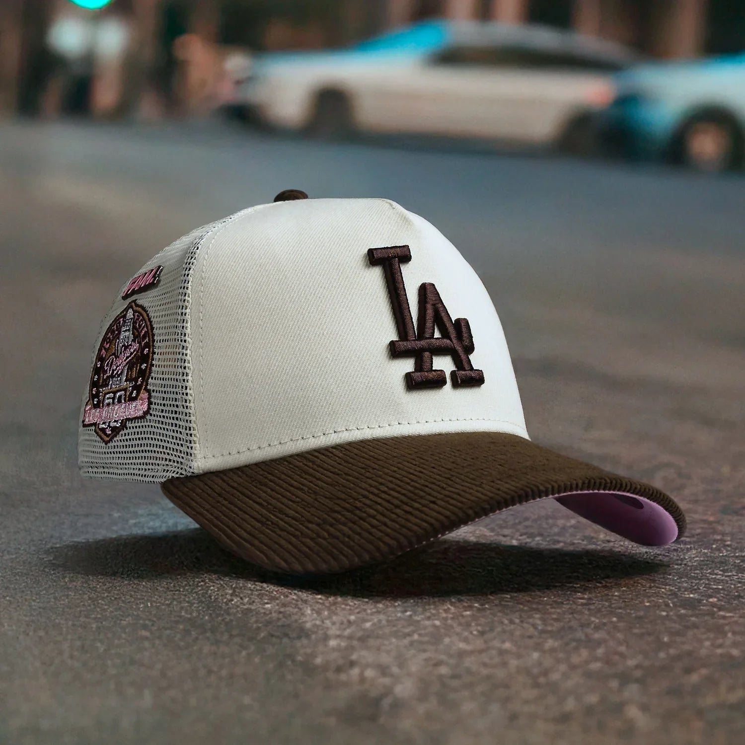 White and brown cap with LA logo on a street