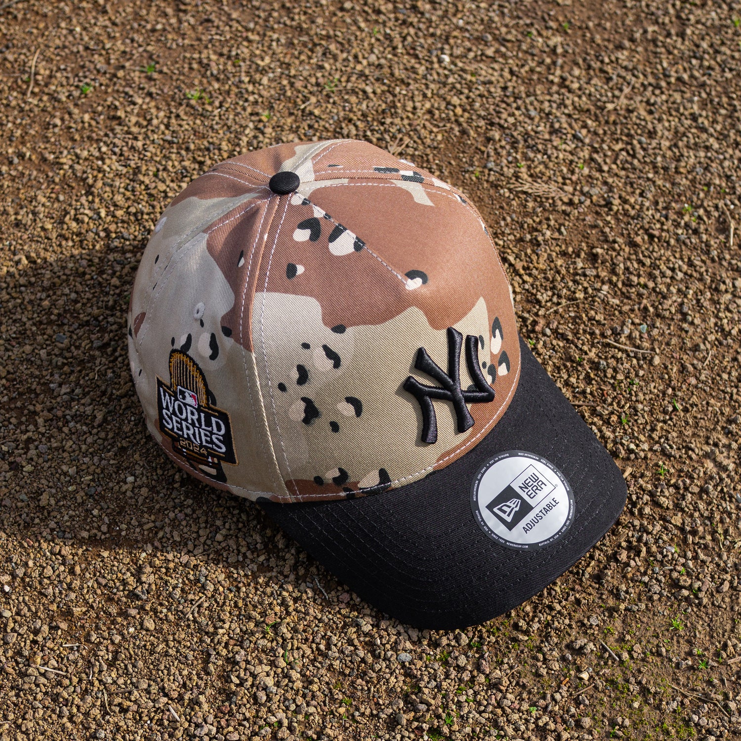 Camouflage baseball cap with New York Yankees logo on a textured surface