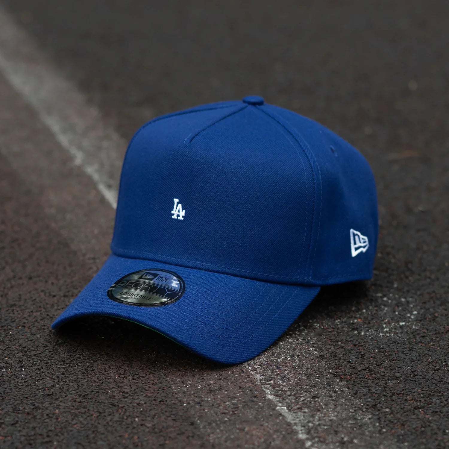 Blue baseball cap with a logo on a textured surface