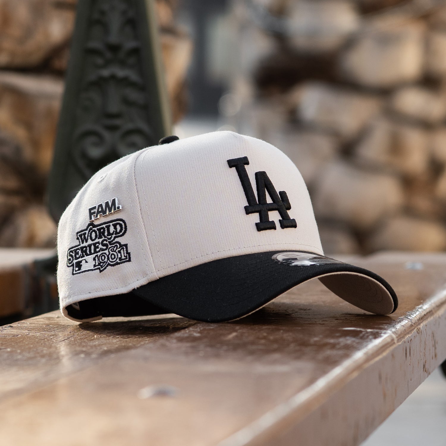White and black baseball cap with LA Dodgers logo on a wooden surface